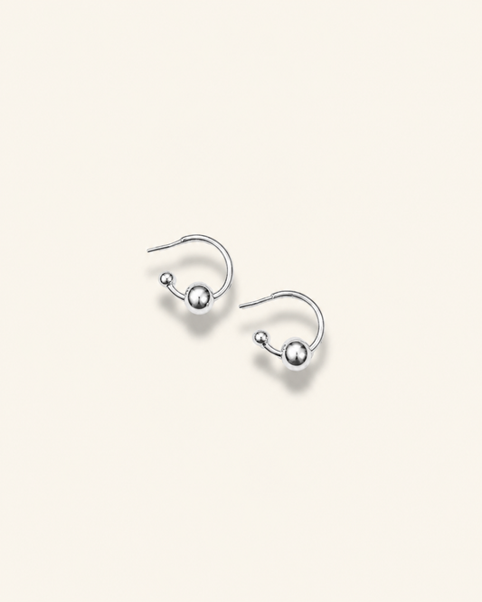 Pair of earrings with blue and yellow circular designs on a white background